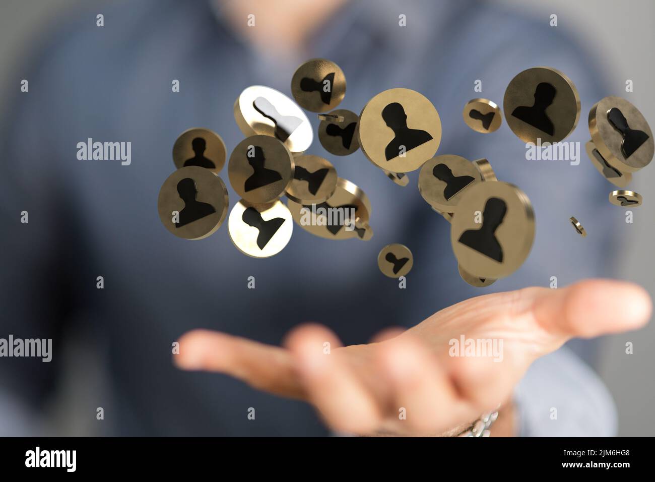 A businessman holding a floating digital render of profile icons ...