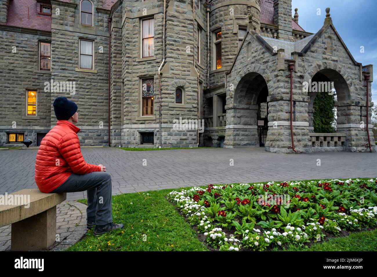 A male looking at the Craigdarroch Castle, Victoria, Vancouver Island, BC Canada Stock Photo
