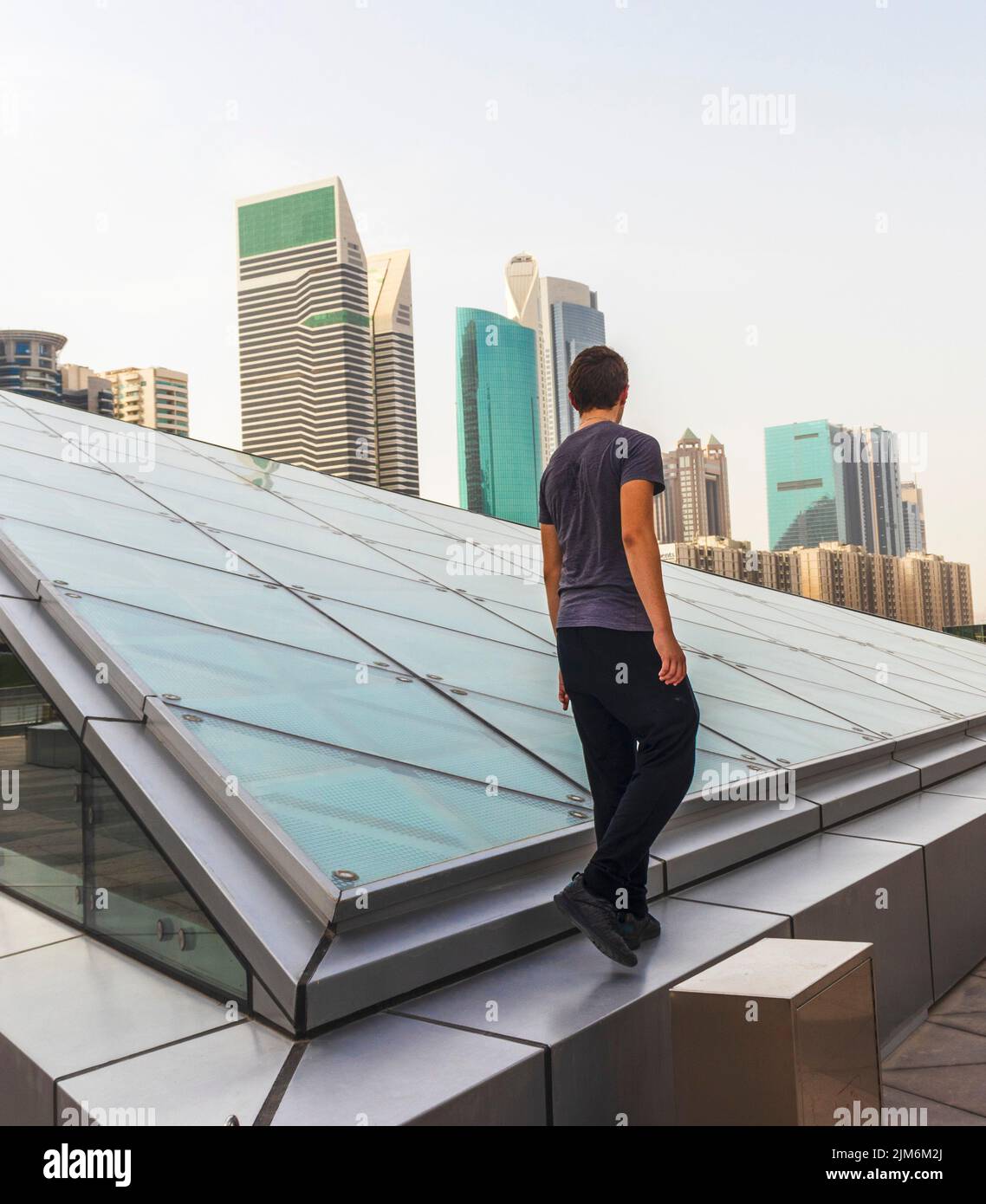 Shot of a young boy with modern city on the background Stock Photo - Alamy