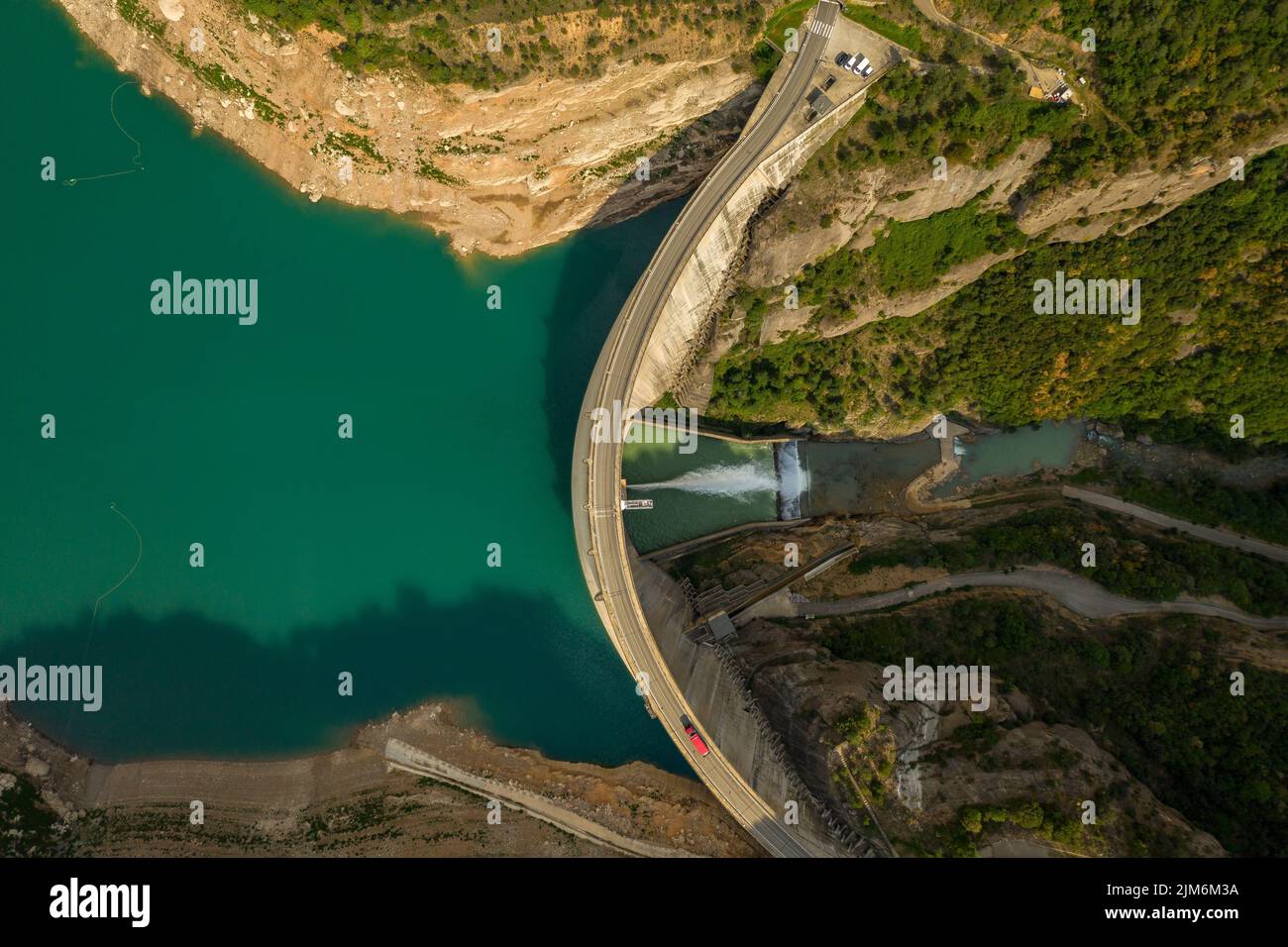 Aerial view of La Llosa del Cavall reservoir dam with little water during summer drought of 2022 (Vall de Lord, Solsonès, Lleida, Catalonia, Spain) Stock Photo