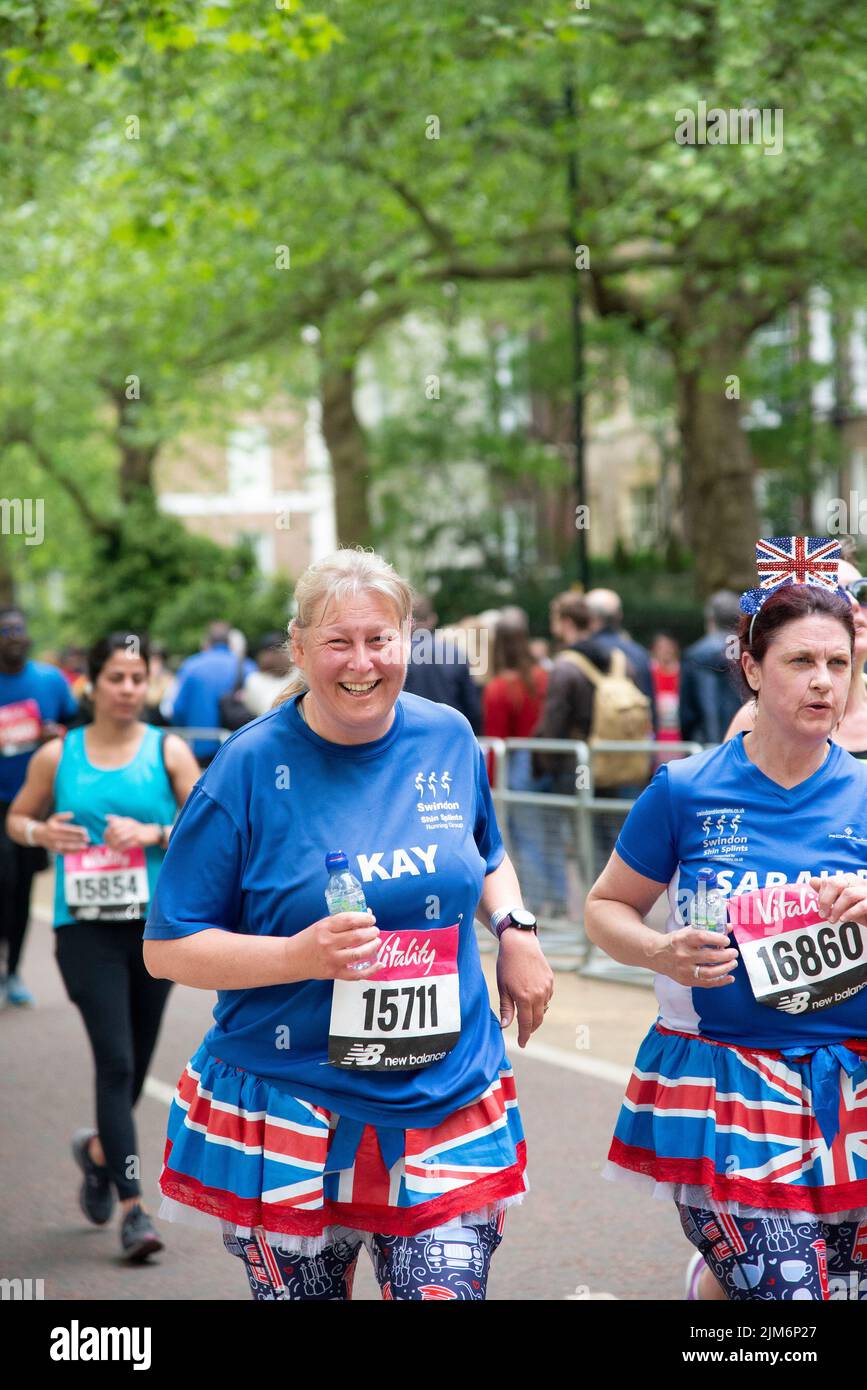 A vertical shot of women runners in Union Jack skirts during Vitality London 10000 Stock Photo