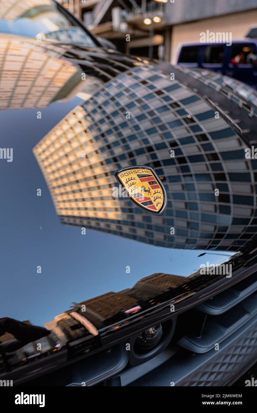 The Brand New 2022 Porsche Cayenne logo on car glass window against a