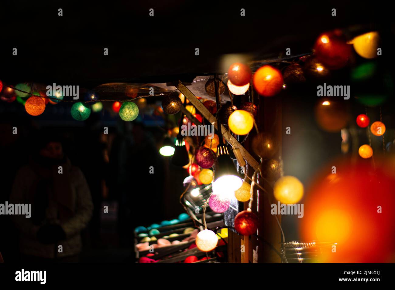 The Christmas lights at the Christmas market on a dark black background Stock Photo