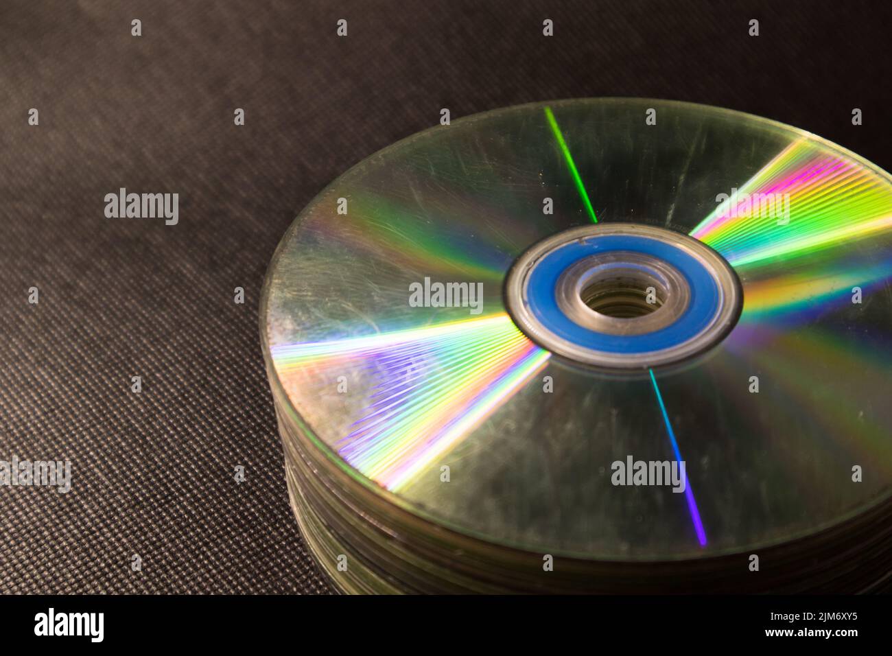 Some old Compact Disk, DVDs stacked in a black surface Stock Photo Alamy