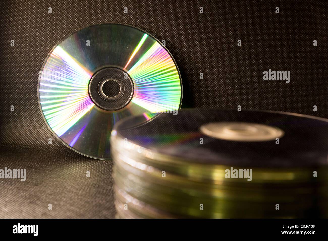 Some old Compact Disk, DVDs stacked in a black surface Stock Photo Alamy