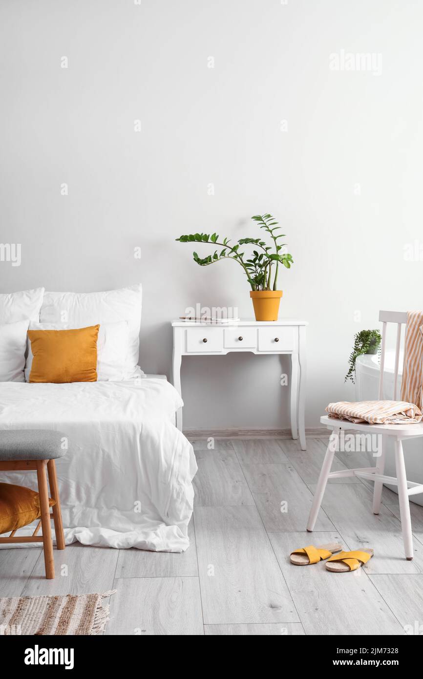 Interior of light bedroom with table and chair Stock Photo Alamy