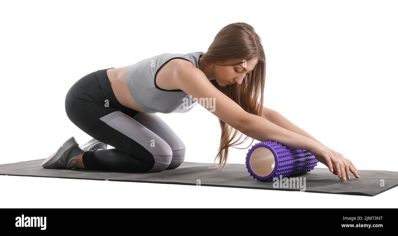 Young woman training with foam roller on white background Stock Photo ...