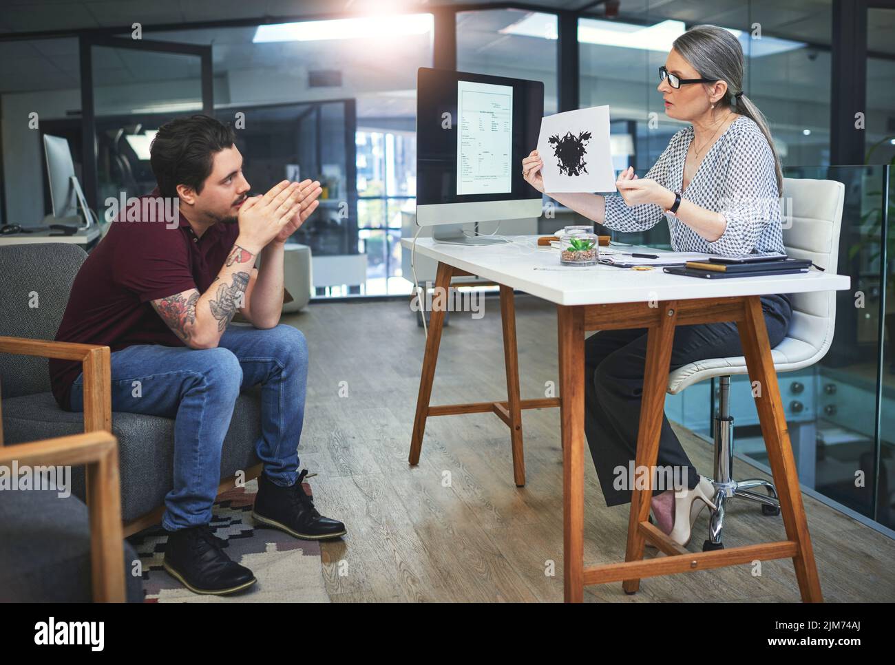 Perception is everything. a mature psychologist conducting an inkblot test with her patient during a therapeutic session. Stock Photo