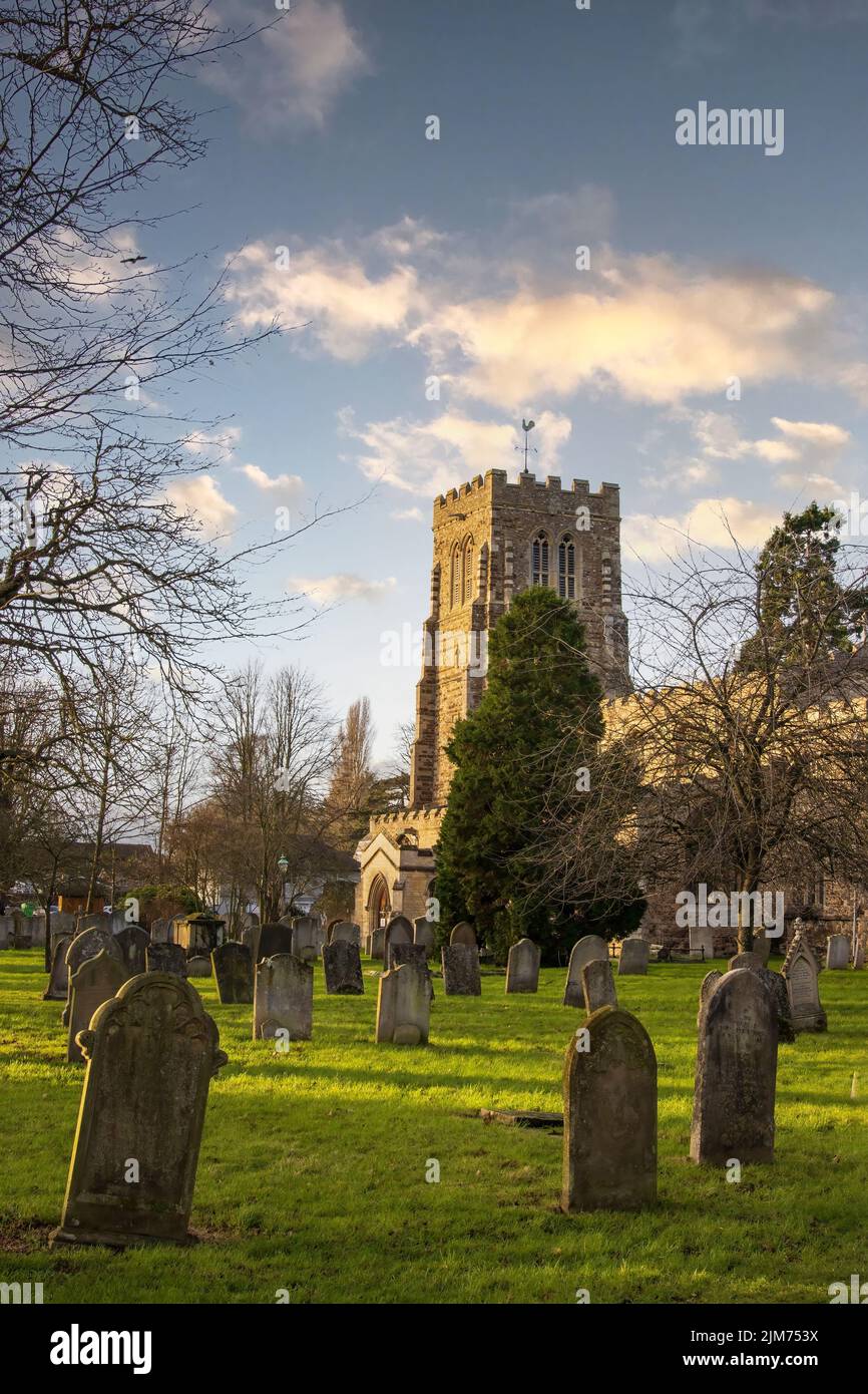 St Neots, UK - December 31st 2021: St Mary's Church tower and grave yard. High Quality Image Stock Photo