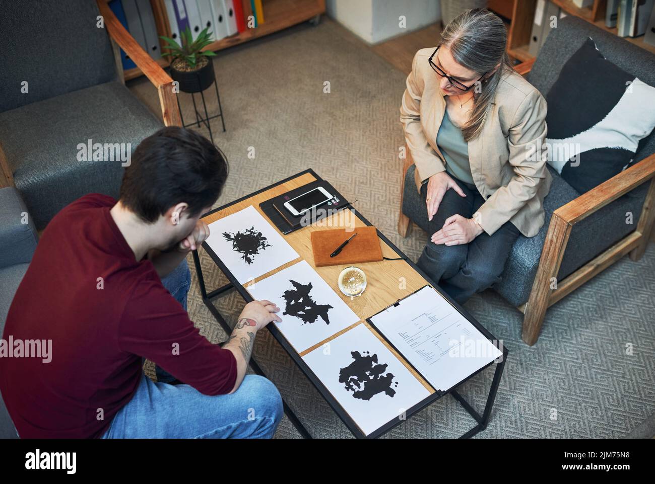 Life is all about how you perceive it. a mature psychologist conducting an inkblot test with her patient during a therapeutic session. Stock Photo