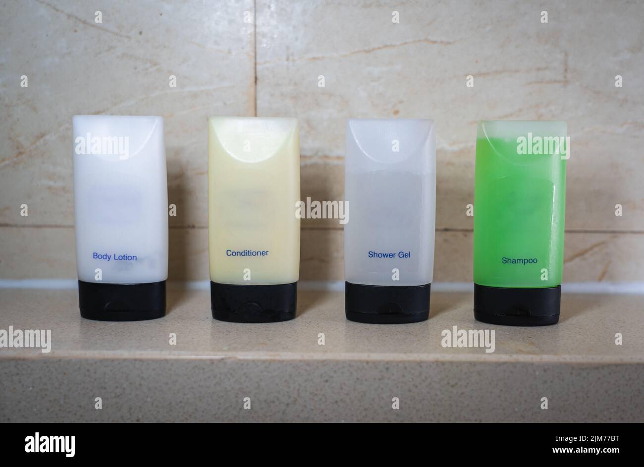 A toiletry set of Body Lotion, Conditioner, Shower Gel and Shampoo on a