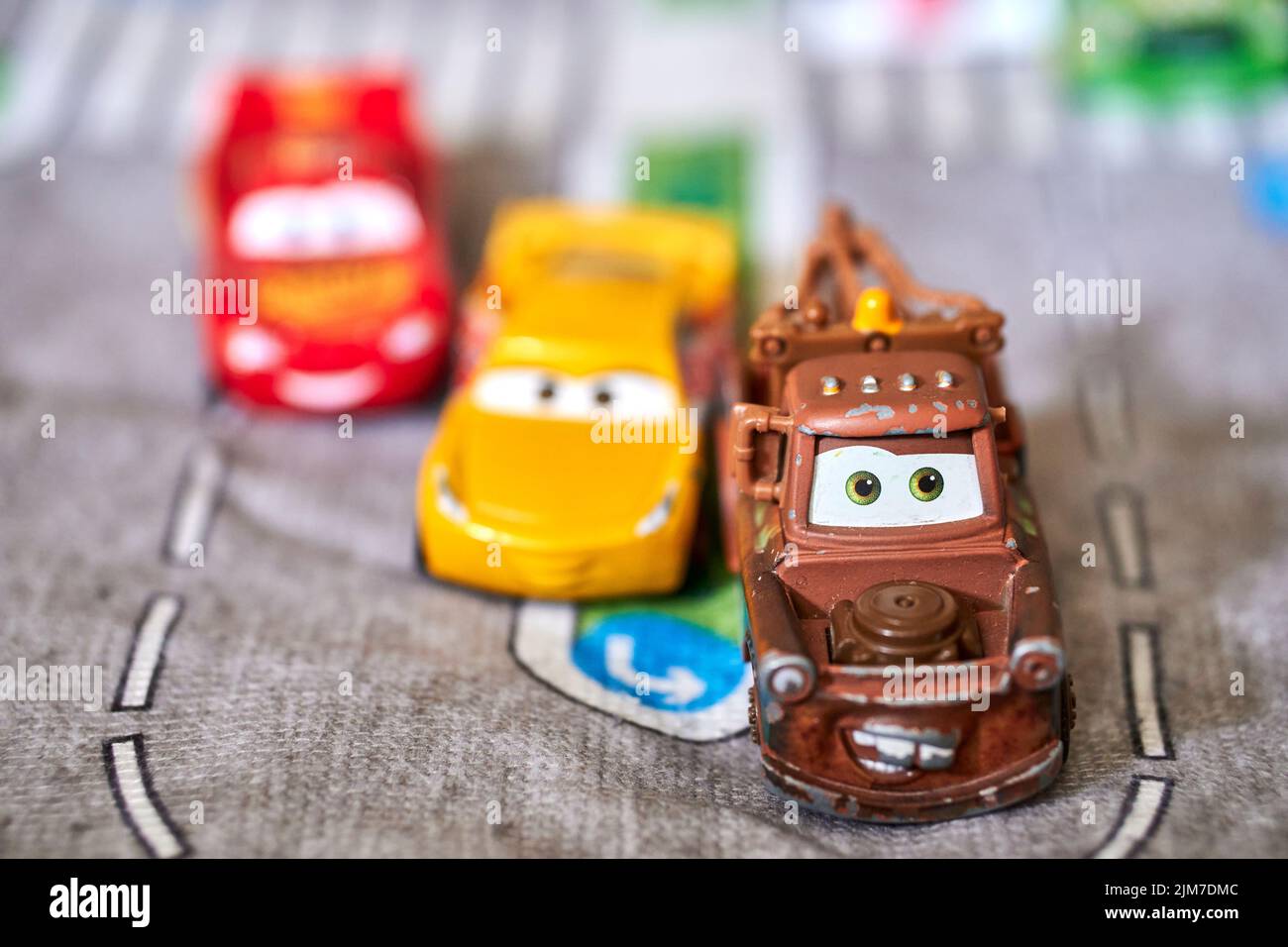 The Mattel toy model cars from the Disney Pixar Cars movie on a playmat