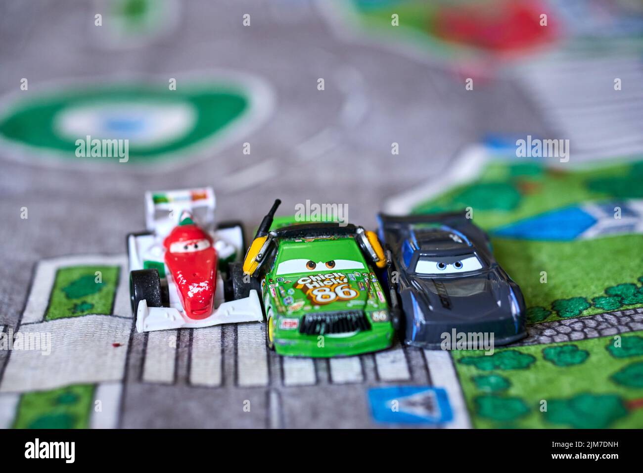 The Mattel toy model cars from the Disney Pixar Cars movie on a playmat