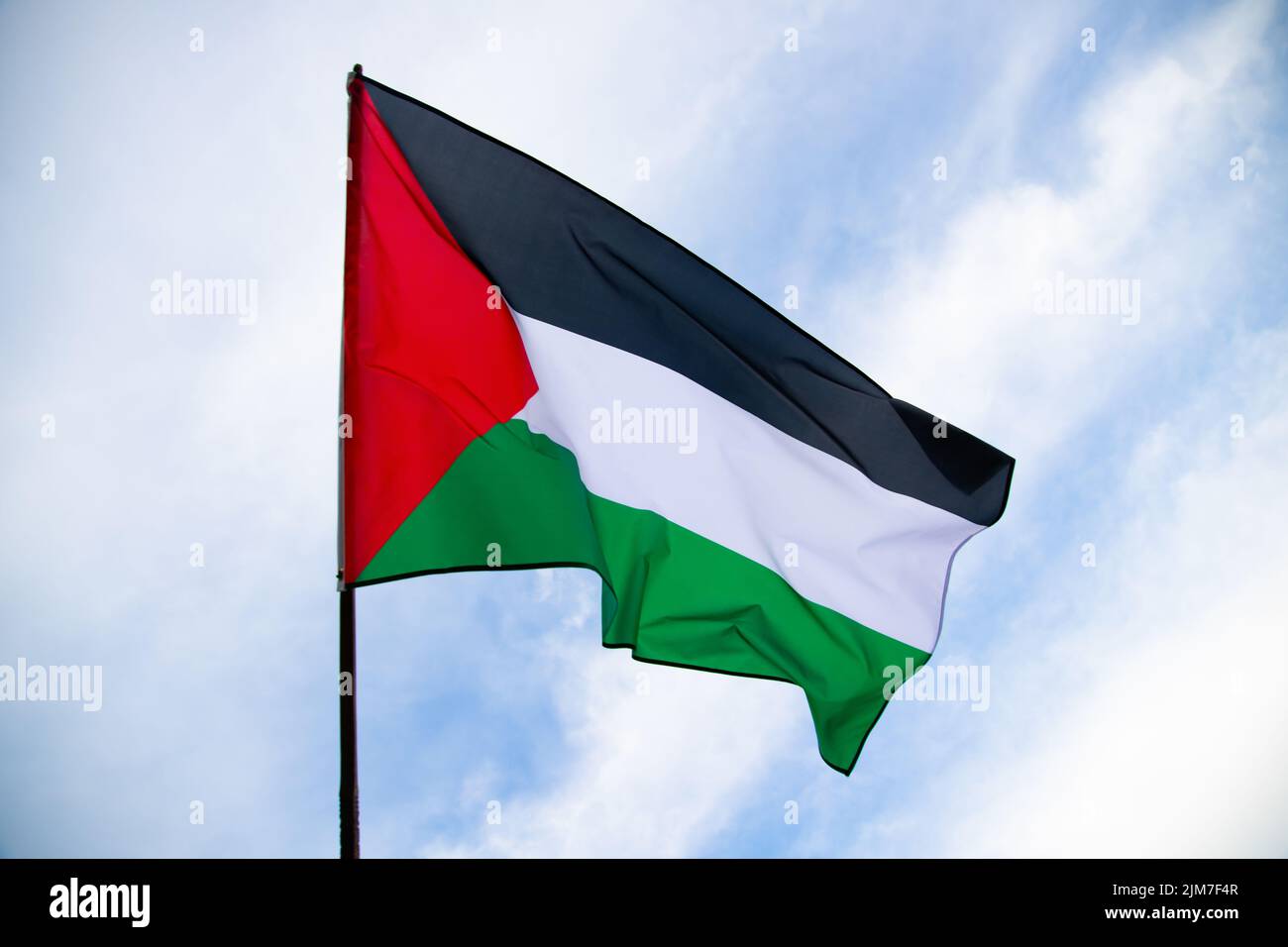 Palestine national flag waving in the wind. International relations concept. Stock Photo