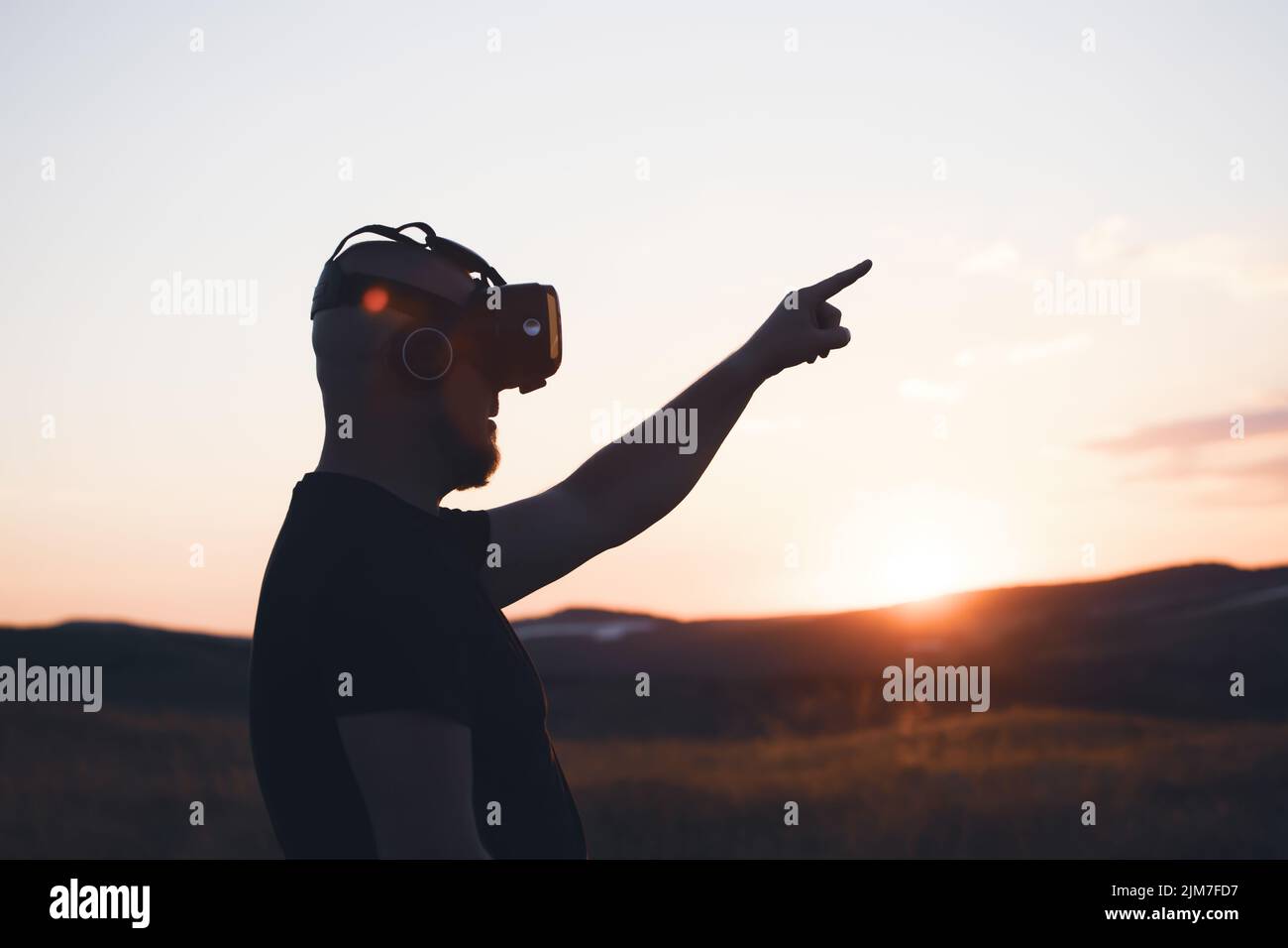 Young man wearing virtual reality goggles. Metaverse, technology, video game, futuristic concept Stock Photo