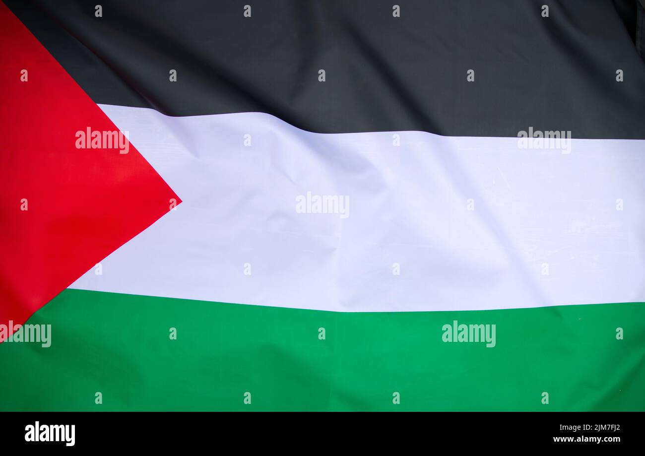 Palestine national flag waving in the wind. International relations concept. Stock Photo
