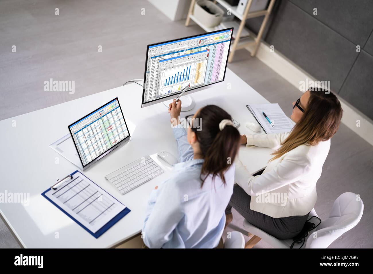 Analyst Employee Working On Spreadsheet Using Desktop Computer Stock Photo