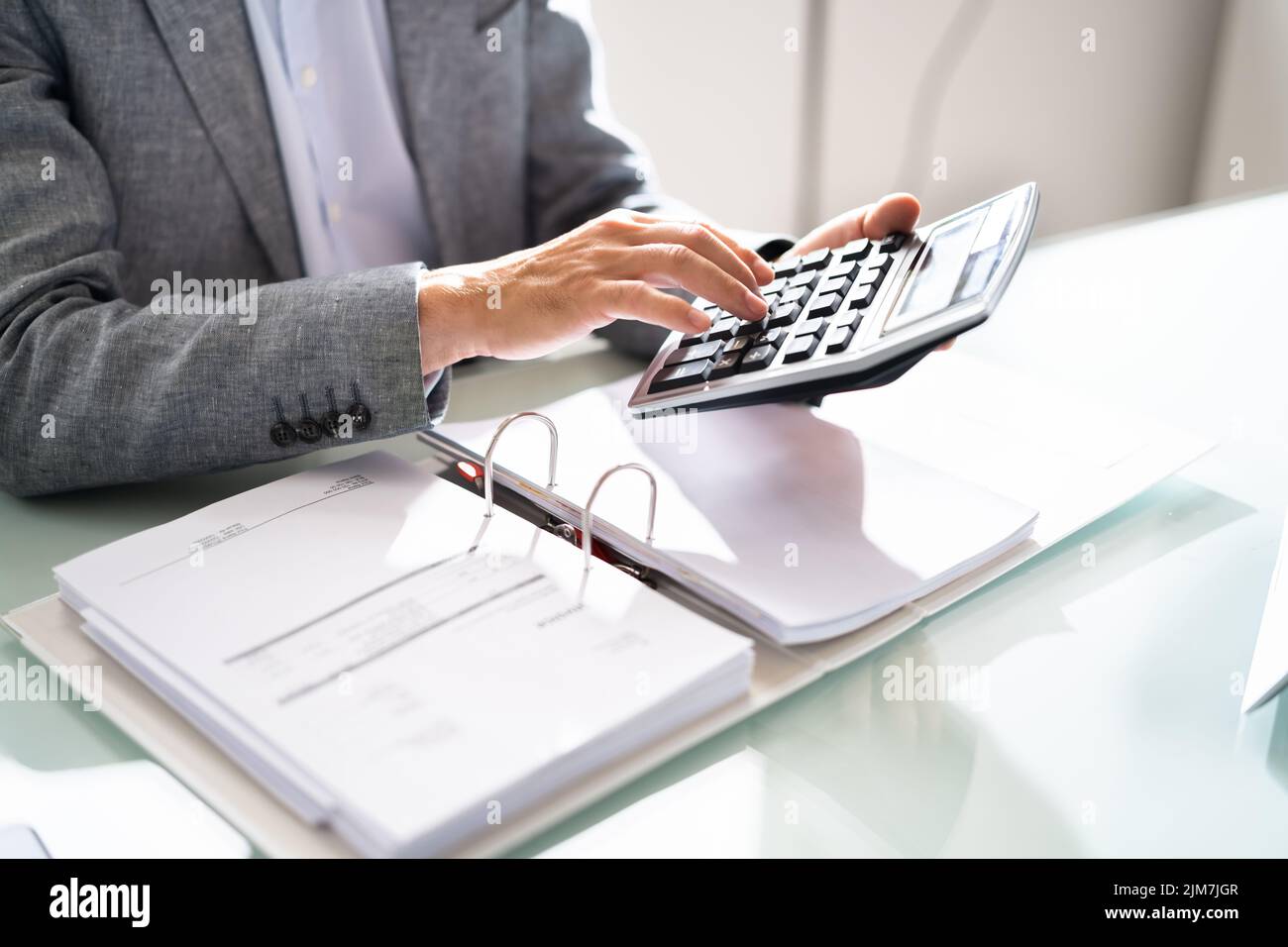 Lady Calculating Invoice. Chartered Accountant With Calculator Stock Photo