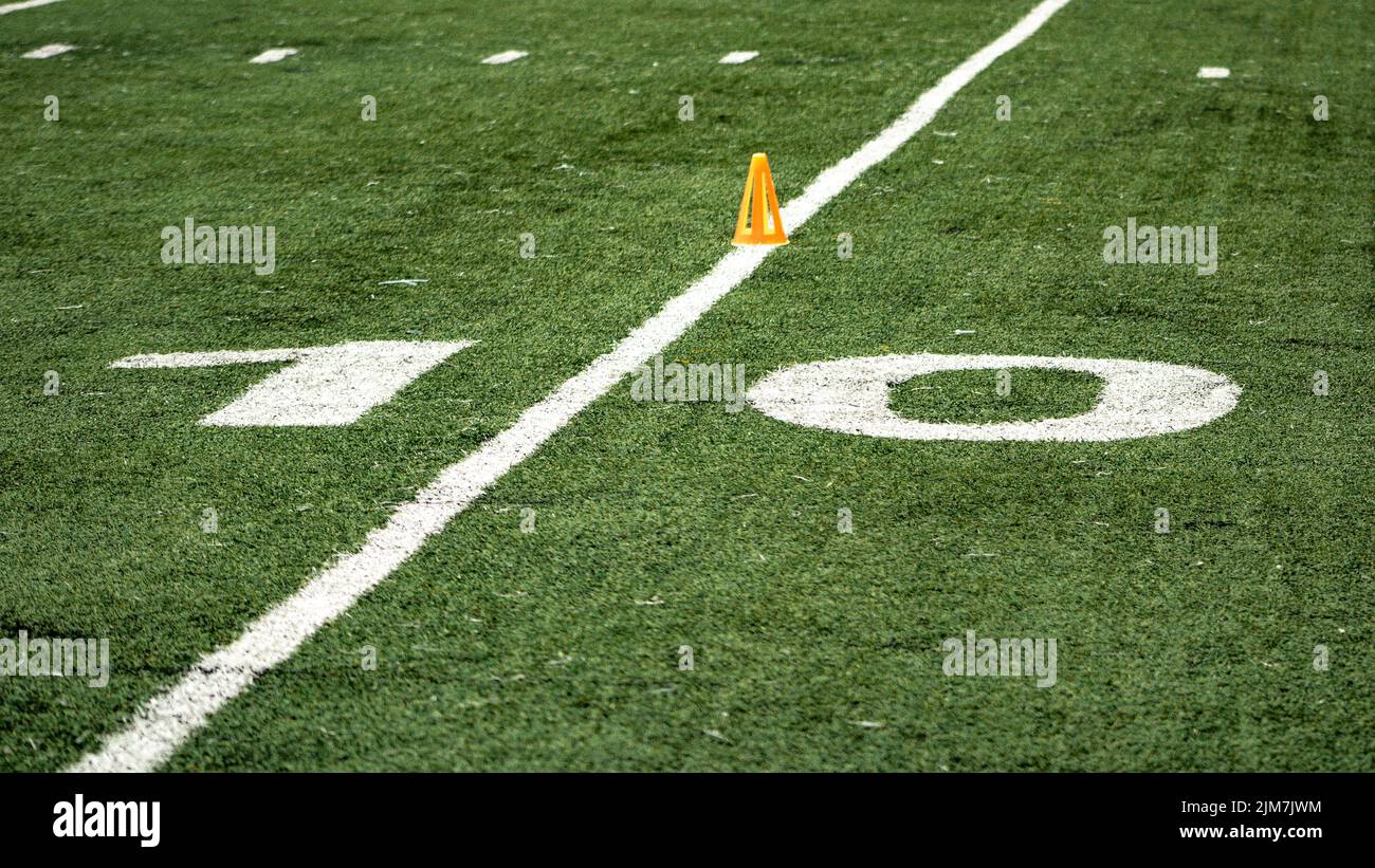 A sign of 10 yards in a flag football field on grass field Stock Photo