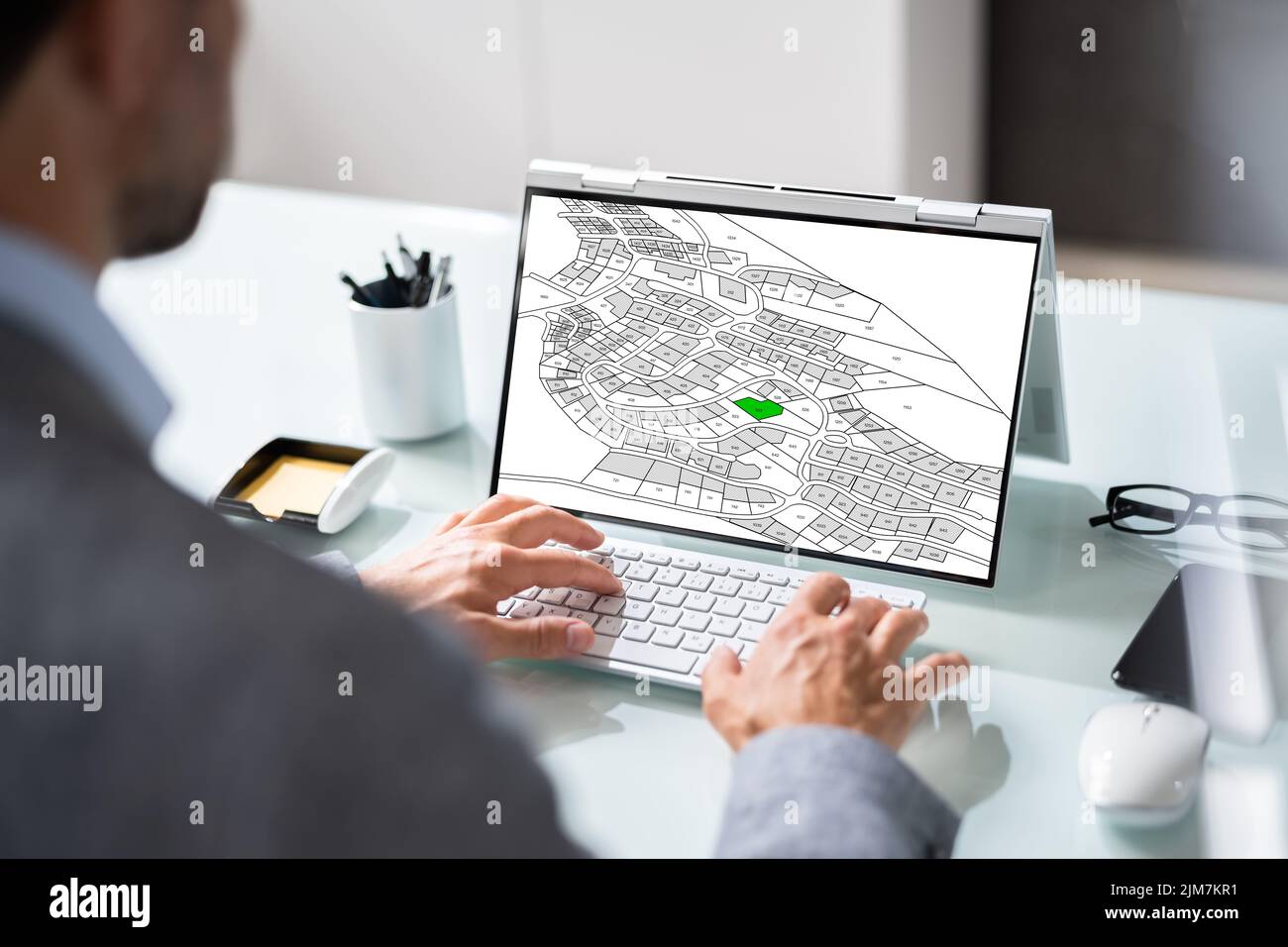 Cadastre Map And City Building Survey On Laptop Stock Photo