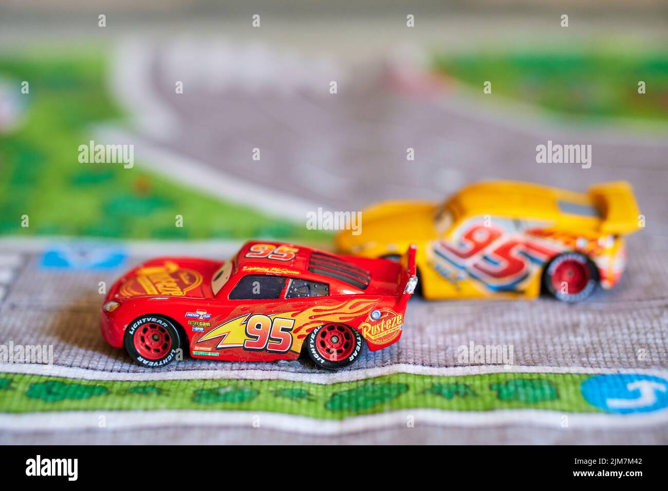 The Mattel toy model cars from the Disney Pixar Cars movie on a playmat