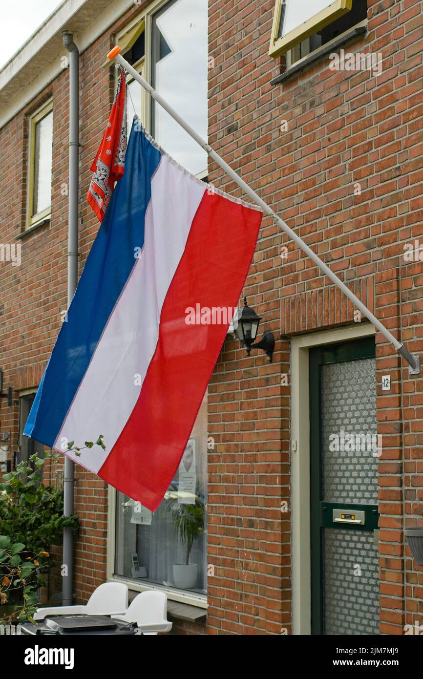 dutch civilians hang flag upside down to support protesting farmers Stock Photo
