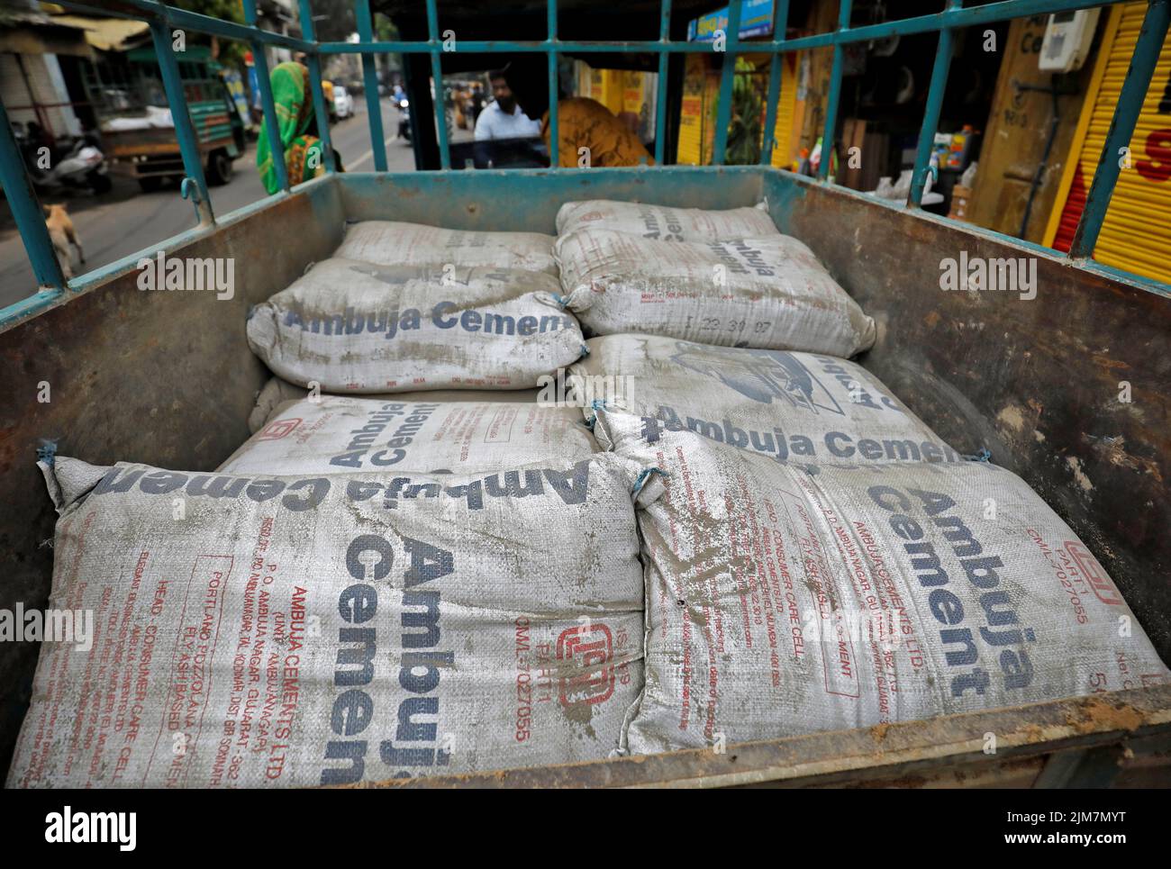 A view shows Ambuja Cement bags, to be carried to a construction site, in a load carrier in Ahmedabad, India, July 29, 2022. REUTERS/Amit Dave Stock Photo