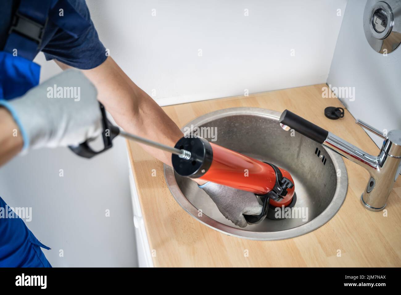 Plumber Cleaning Drain And Sink Using Pump Stock Photo Alamy