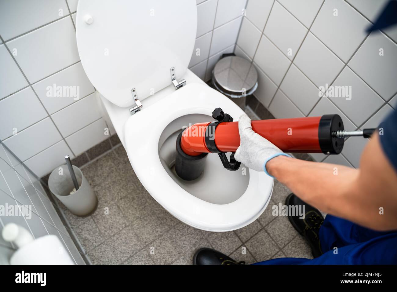 Plumber Toilet Blockage Assistance. WC Cleaning And Plumbing Stock Photo