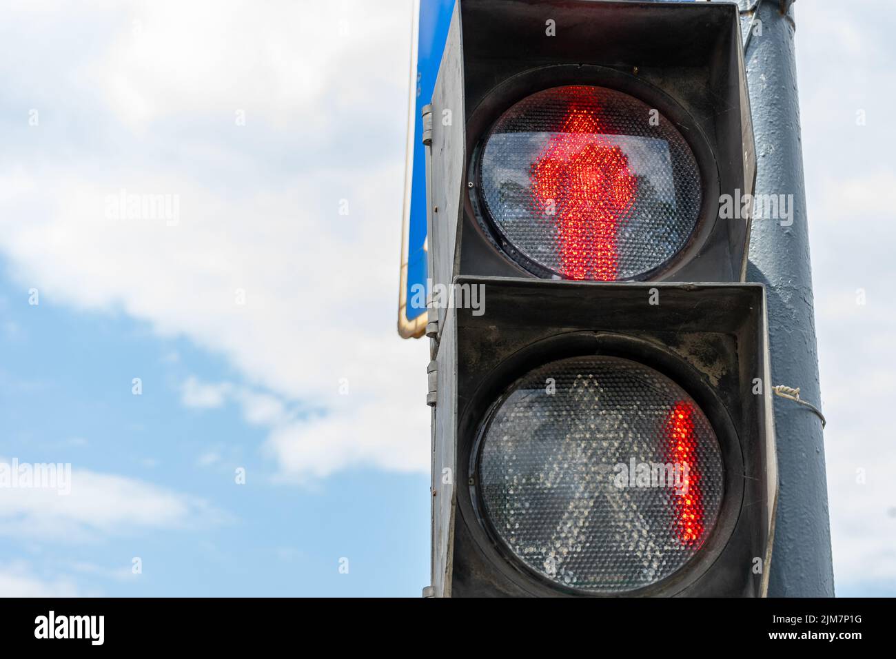 Red traffic light for pedestrians on the background of the blue sky. Red number 1 at the traffic light. Place for writing, copy space. Stock Photo