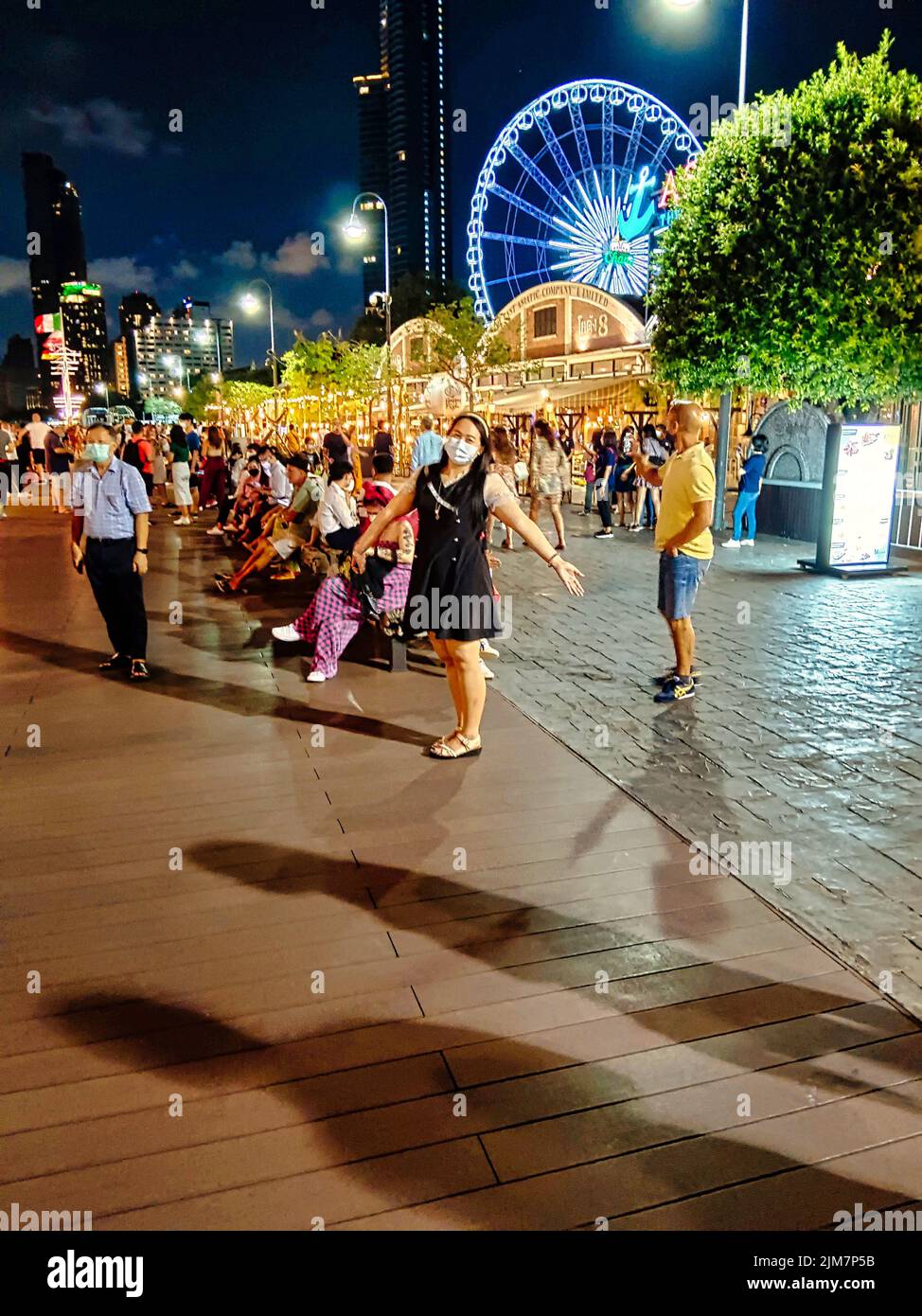 A vertical shot of people at Asiatique: The Riverfront, a large open-air mall in Bangkok, Thailand Stock Photo