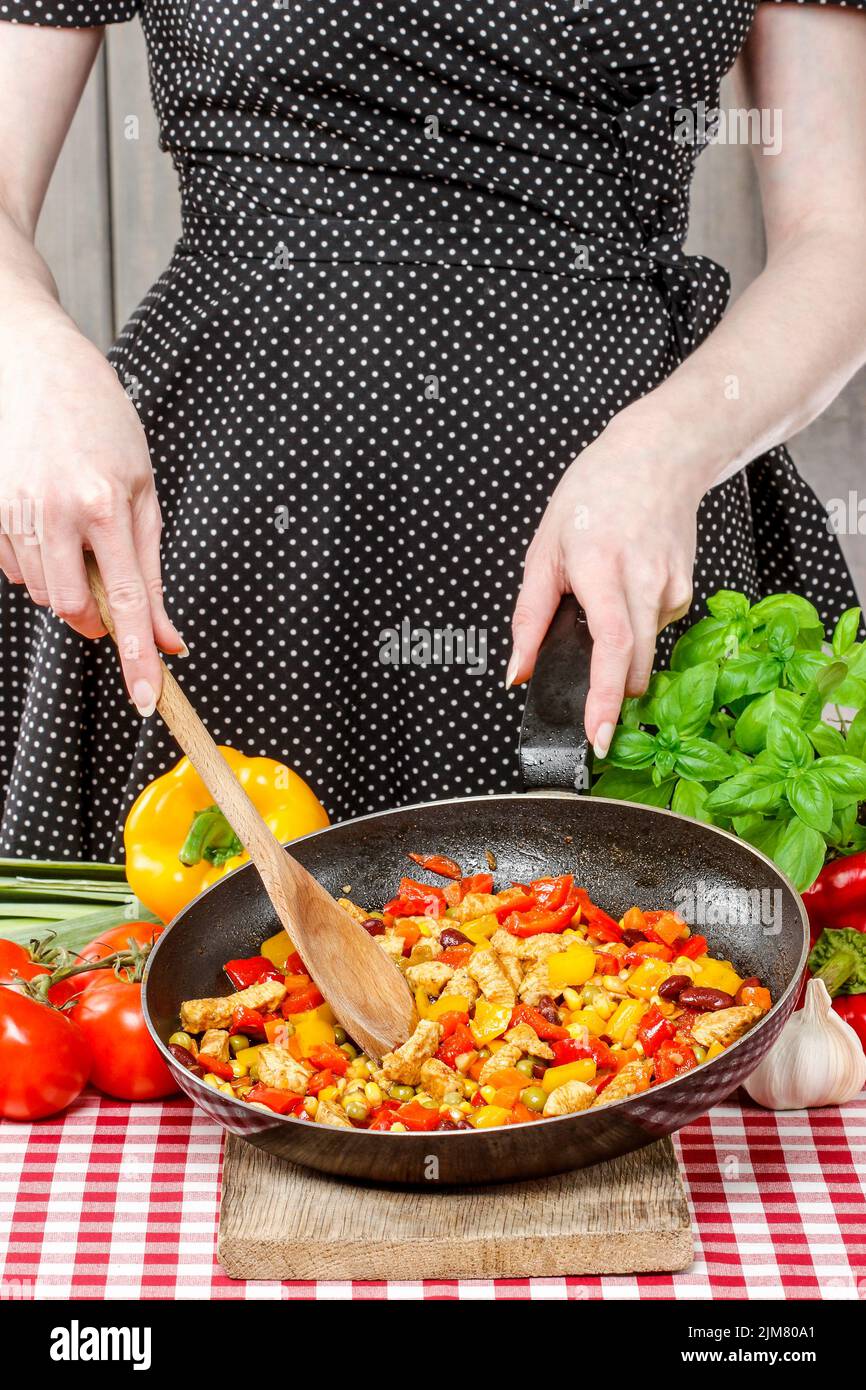 Housewife cooking mexican style dish. Party dish Stock Photo