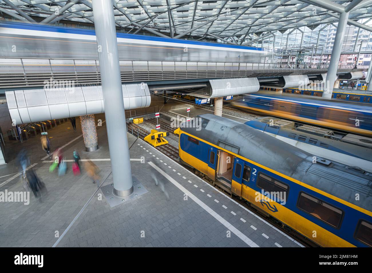 Trains and trams arriving and departing Den Haag Central station in the Netherlands Stock Photo