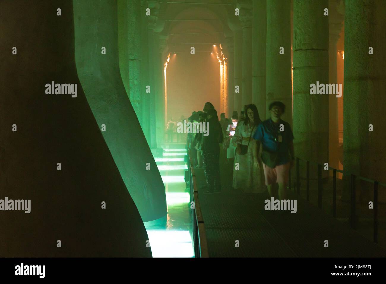 Tourists in the Basilica Cistern or Yerebatan Sarnici. Travel to Turkey background photo. Noise and grain included. Selective focus. Istanbul Turkey - Stock Photo