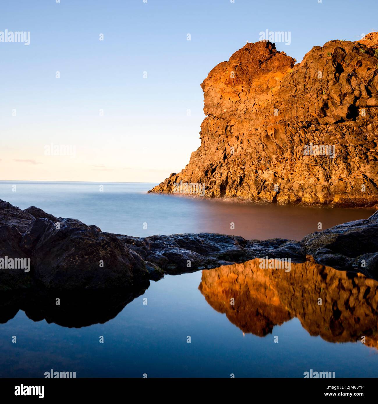 Reflection of cliff at coast of Madeira Stock Photo