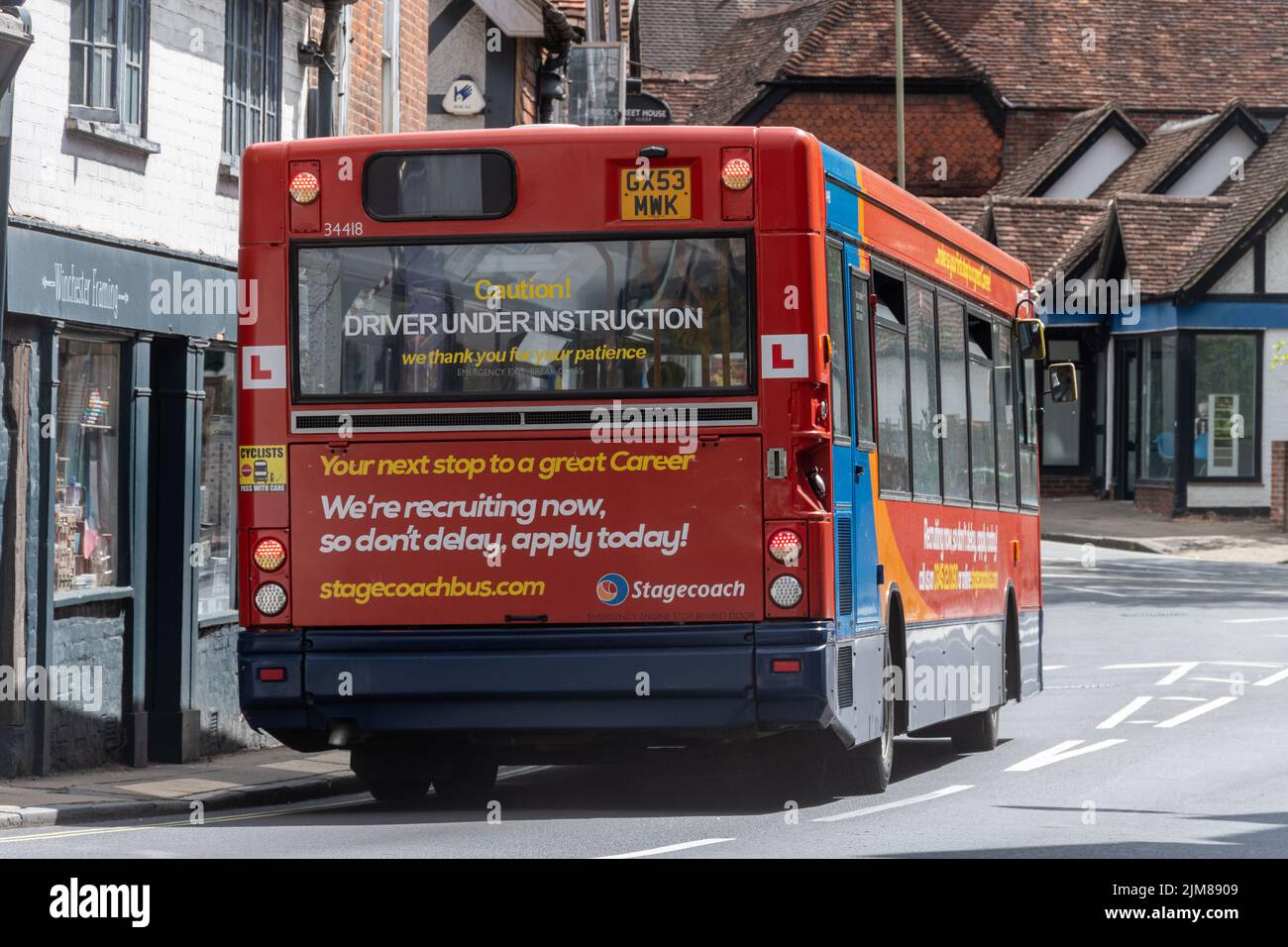 Bus driver under instruction, stagecoach bus with L plates and recruiting now message, UK. Shortage of bus drivers, 2022 Stock Photo
