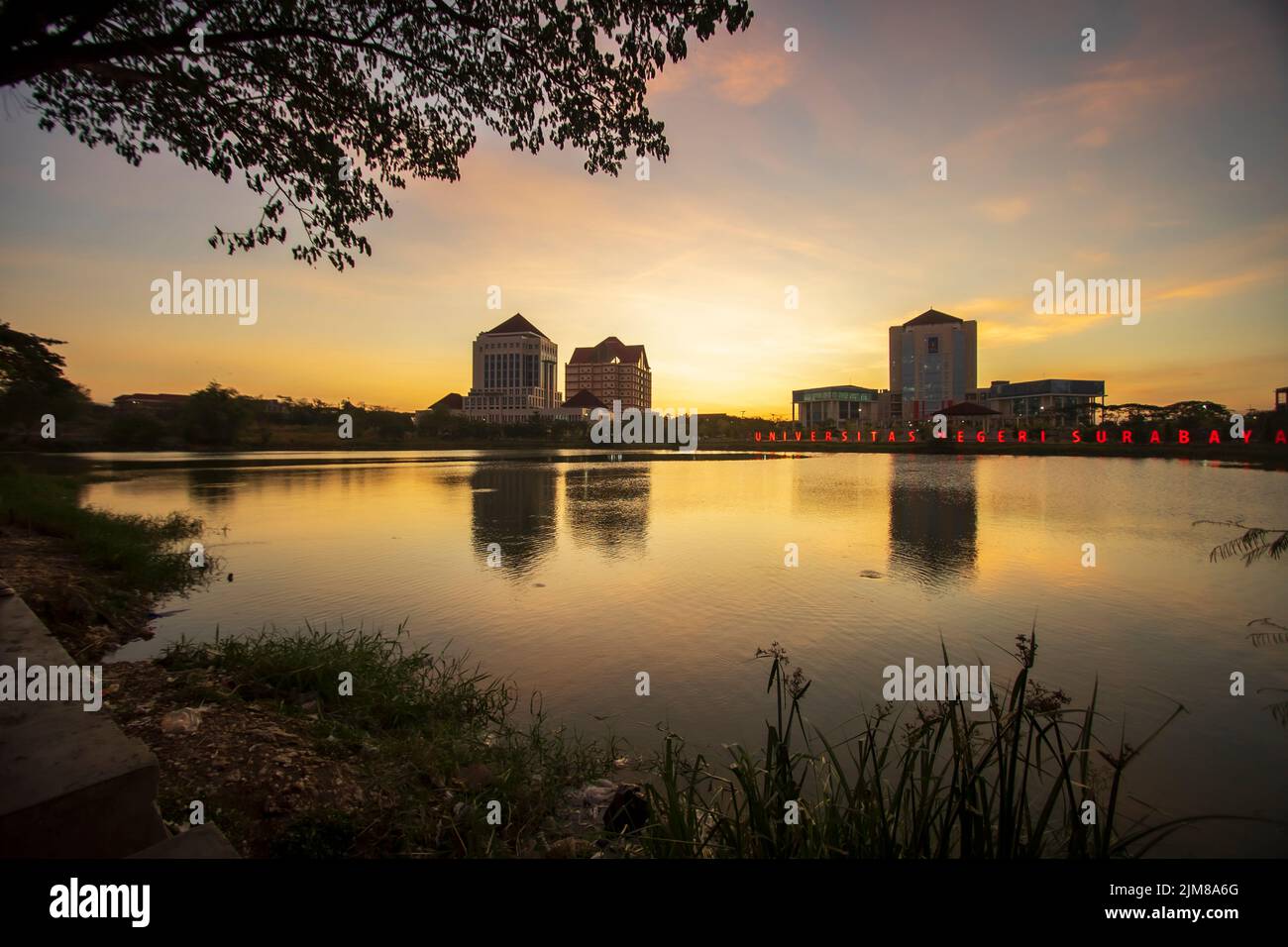 Unesa lake with reflections of buildings, Indonesia Stock Photo