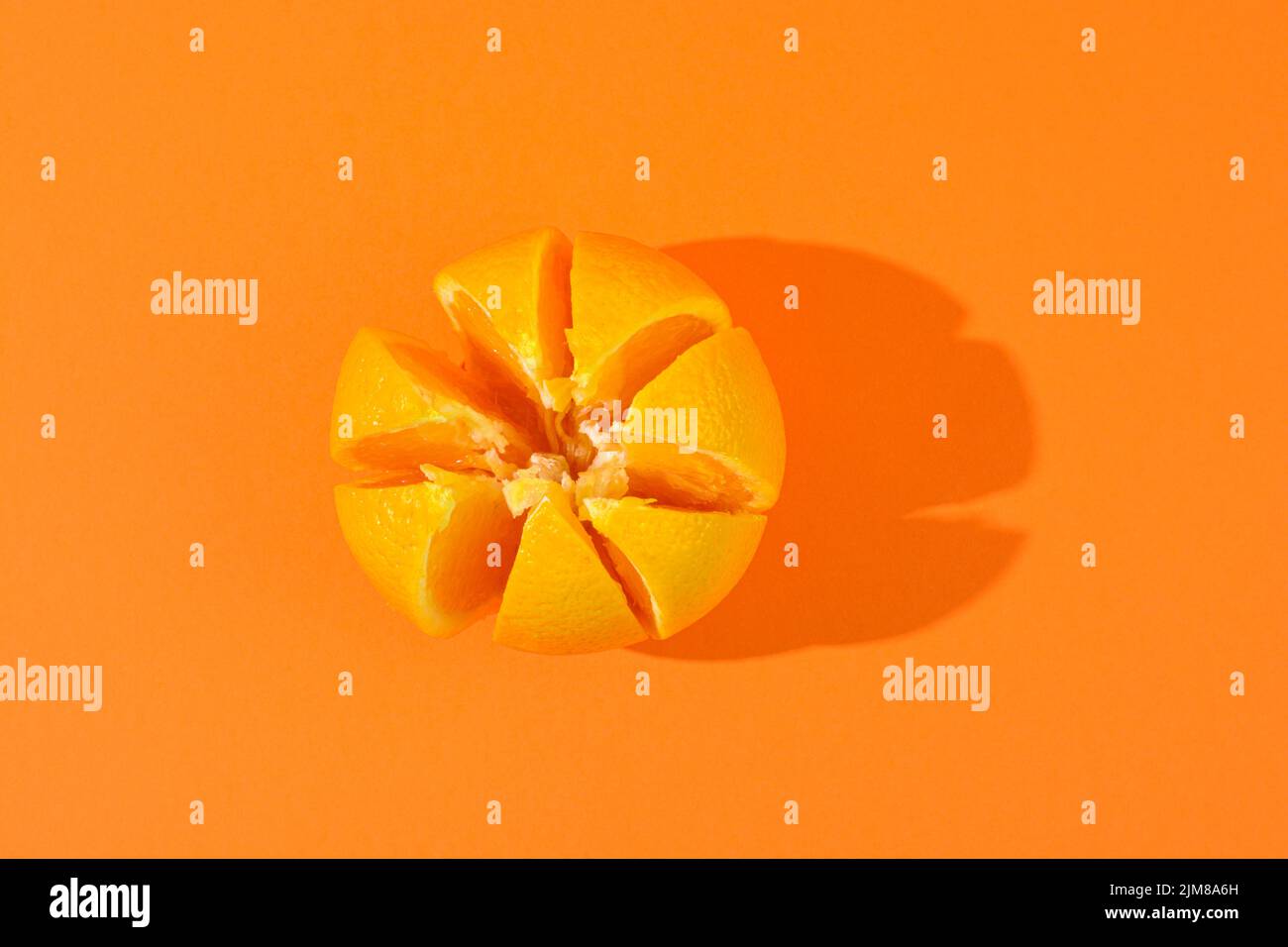 Orange fruit sliced on an orange background Stock Photo