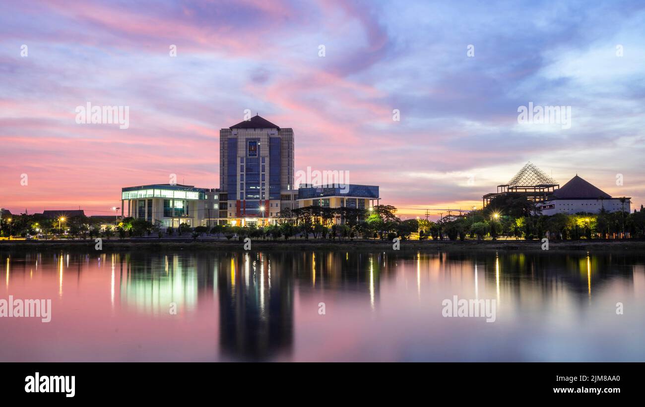 Unesa lake with reflections of buildings, Indonesia Stock Photo