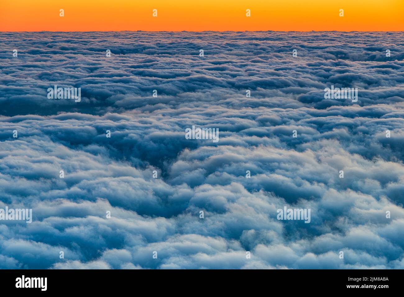 Above the clouds at sunrise Stock Photo