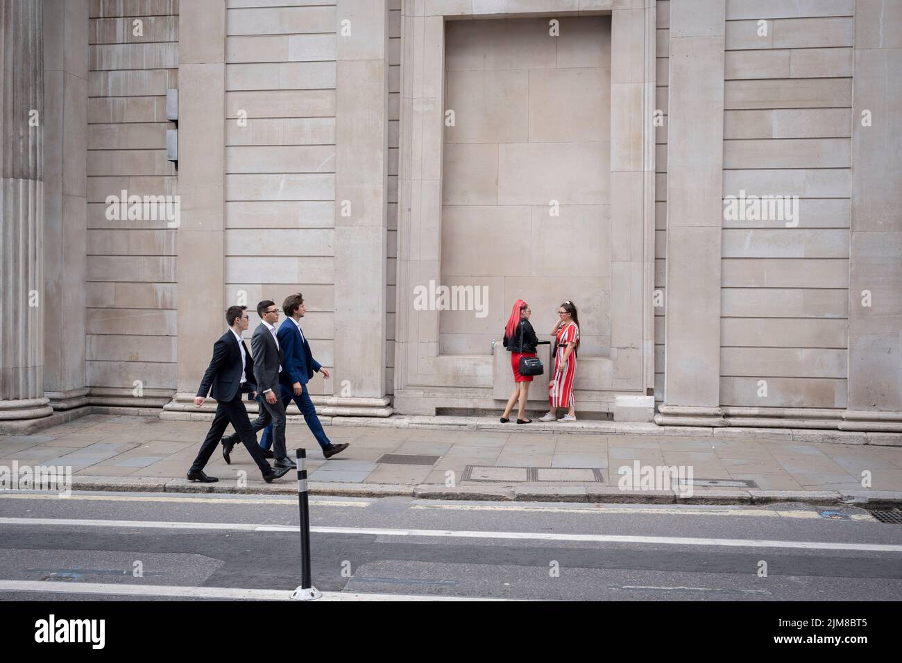 On the day that the Bank of England announced a rise, from 1.25% to 1.75% in the interest rate, the highest increase in 27 years, Londoners walk beneath the tall walls of the Bank of England, on 4th August 2022, in the City of London, England. This increase is widely seen as a slide towards inflation with a shrinking of the UK economy - the start of its fall into recession in the third financial quarter of 2022. Stock Photo