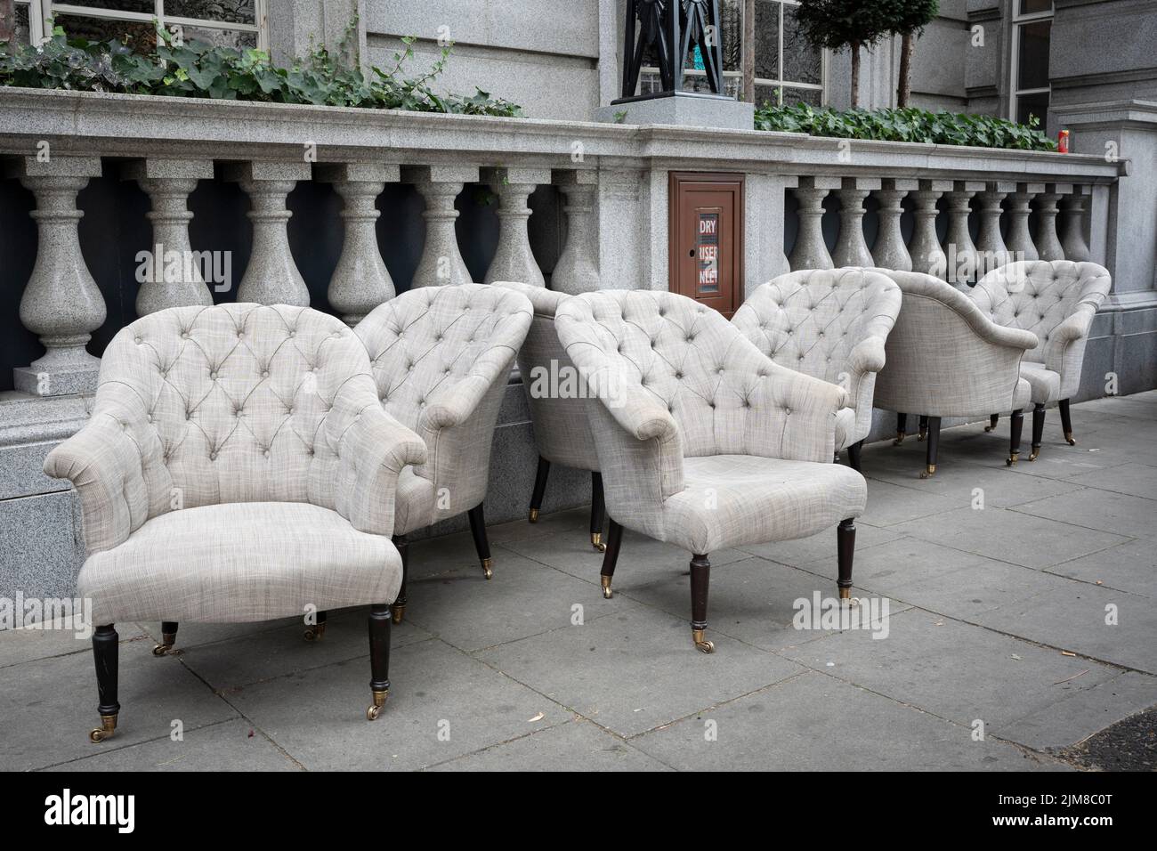 Armchairs are lined-up outside a London hotel, awaiting removal by contractors in the capital, on 3rd August 2022, in London, England. Stock Photo