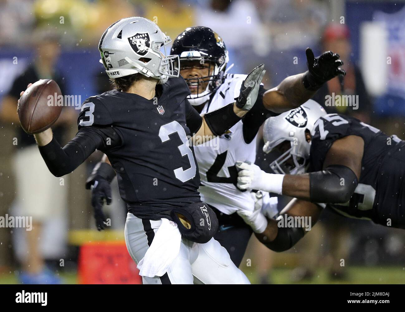 Canton, United States. 04th Aug, 2022. Las Vegas Raiders Jarrett Stidham (3) is hit by Jacksonville Jaguars Travon Walker (44) as he is blocked by Raiders lineman Jermaine Eluemunor (75) in the first quarter of the Pro Football Hall of Game in Canton, Ohio, on Thursday, August 4, 2022. Photo by Aaron Josefczyk/UPI Credit: UPI/Alamy Live News Stock Photo