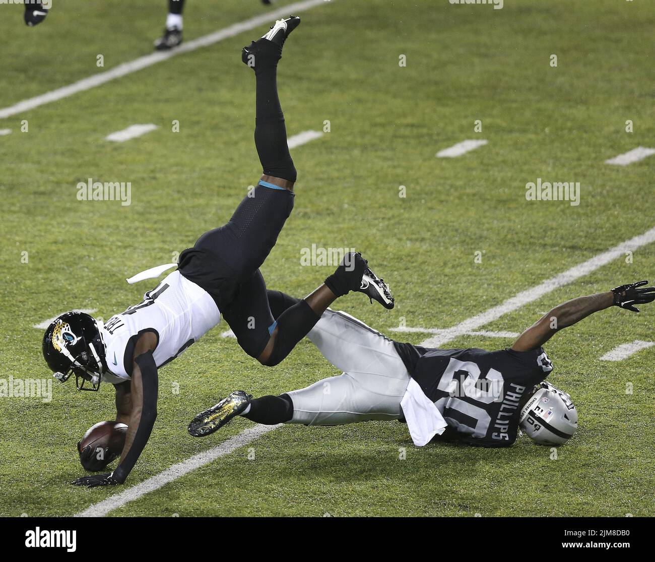 Canton, United States. 04th Aug, 2022. Jacksonville Jaguars Laquon Treadwell (18) is flipped up into the air by Las Vegas Raiders Darius Phillips (20) after making a catch in the first half of the Pro Football Hall of Game against the Las Vegas Raiders in Canton, Ohio, on Thursday, August 4, 2022. Photo by Aaron Josefczyk/UPI Credit: UPI/Alamy Live News Stock Photo