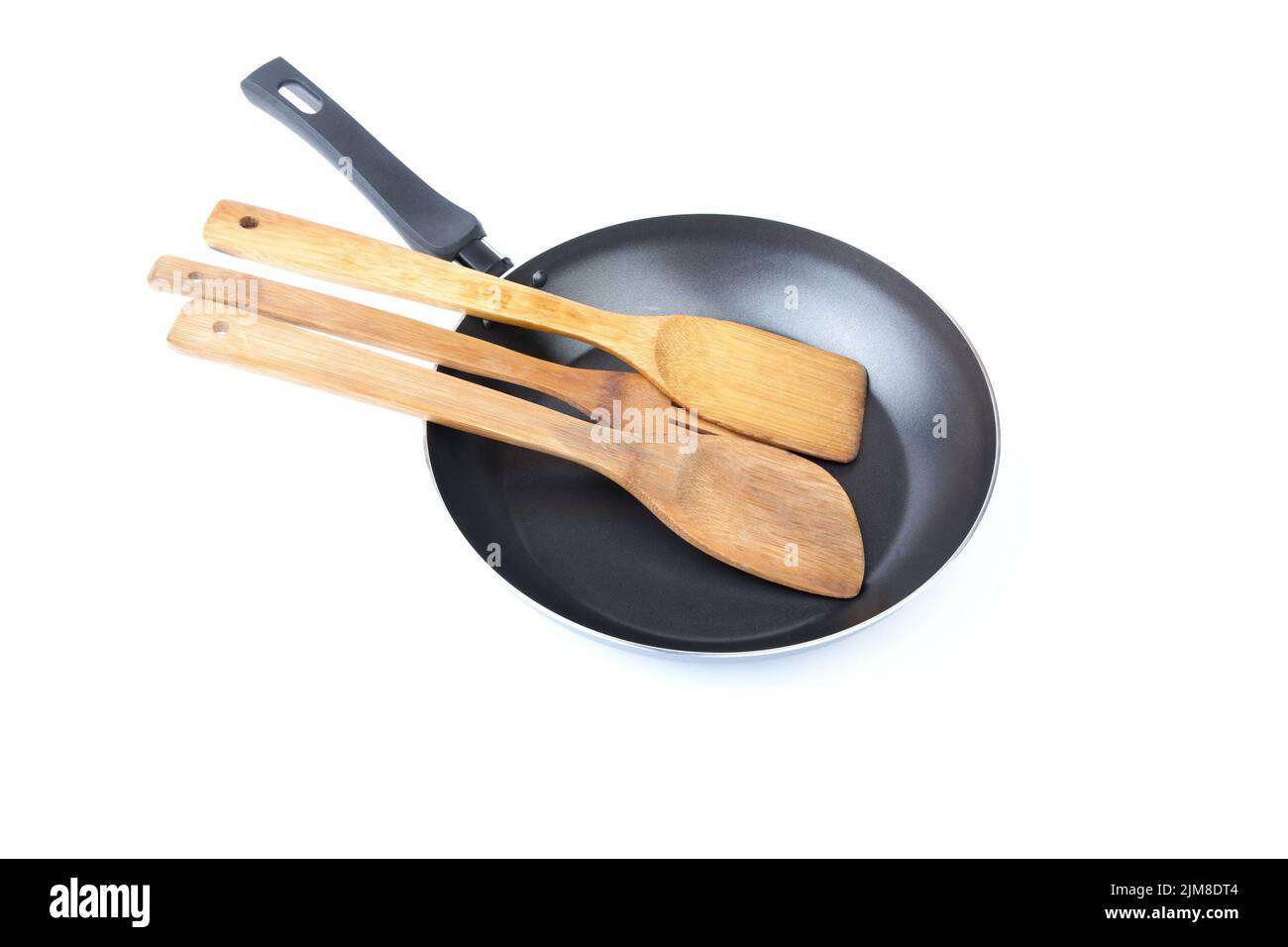 Wooden kitchen shovel in a frying pan Stock Photo