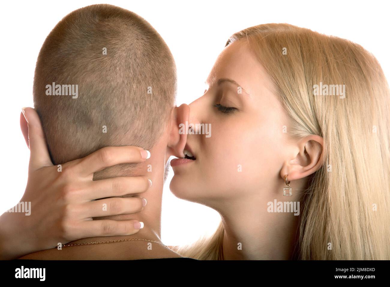 The girl bites an ear of the young man Stock Photo