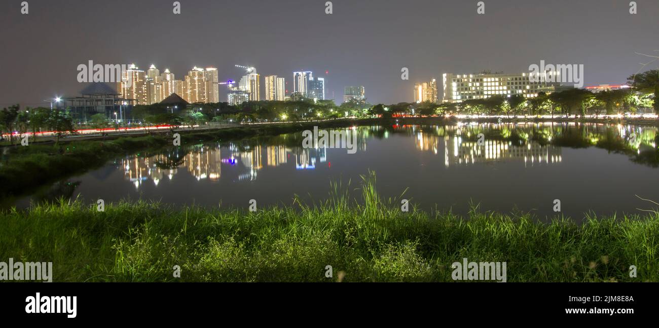 Wonderful cityscape during sunset over the Unesa lake, glowing in night. wonderful picturesque scene. color in night Stock Photo