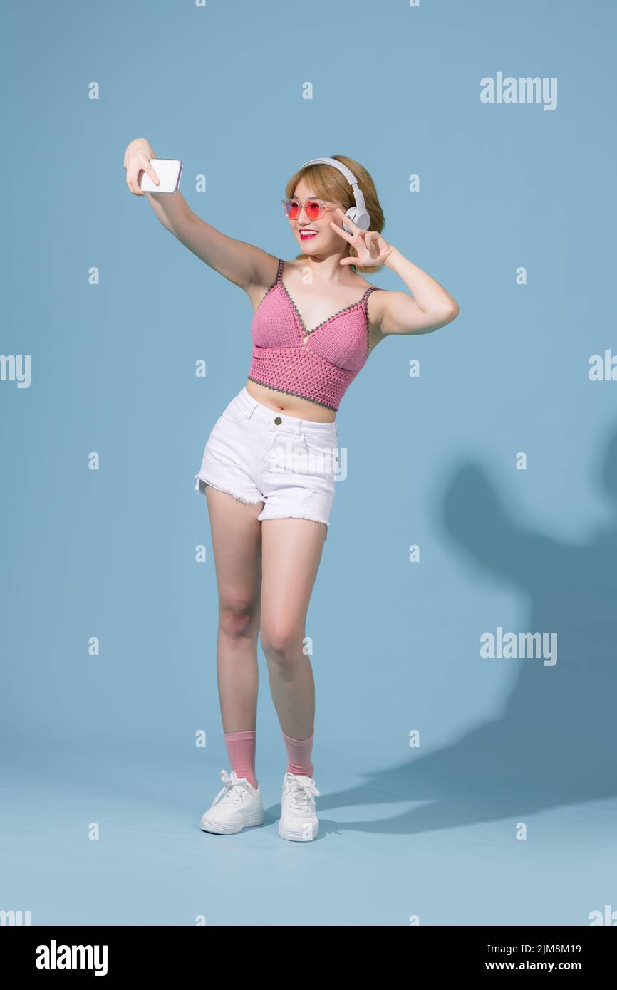 Full length body size view of pretty cheerful skinny girl listening different song rock dancing isolated on pink pastel color background Stock Photo