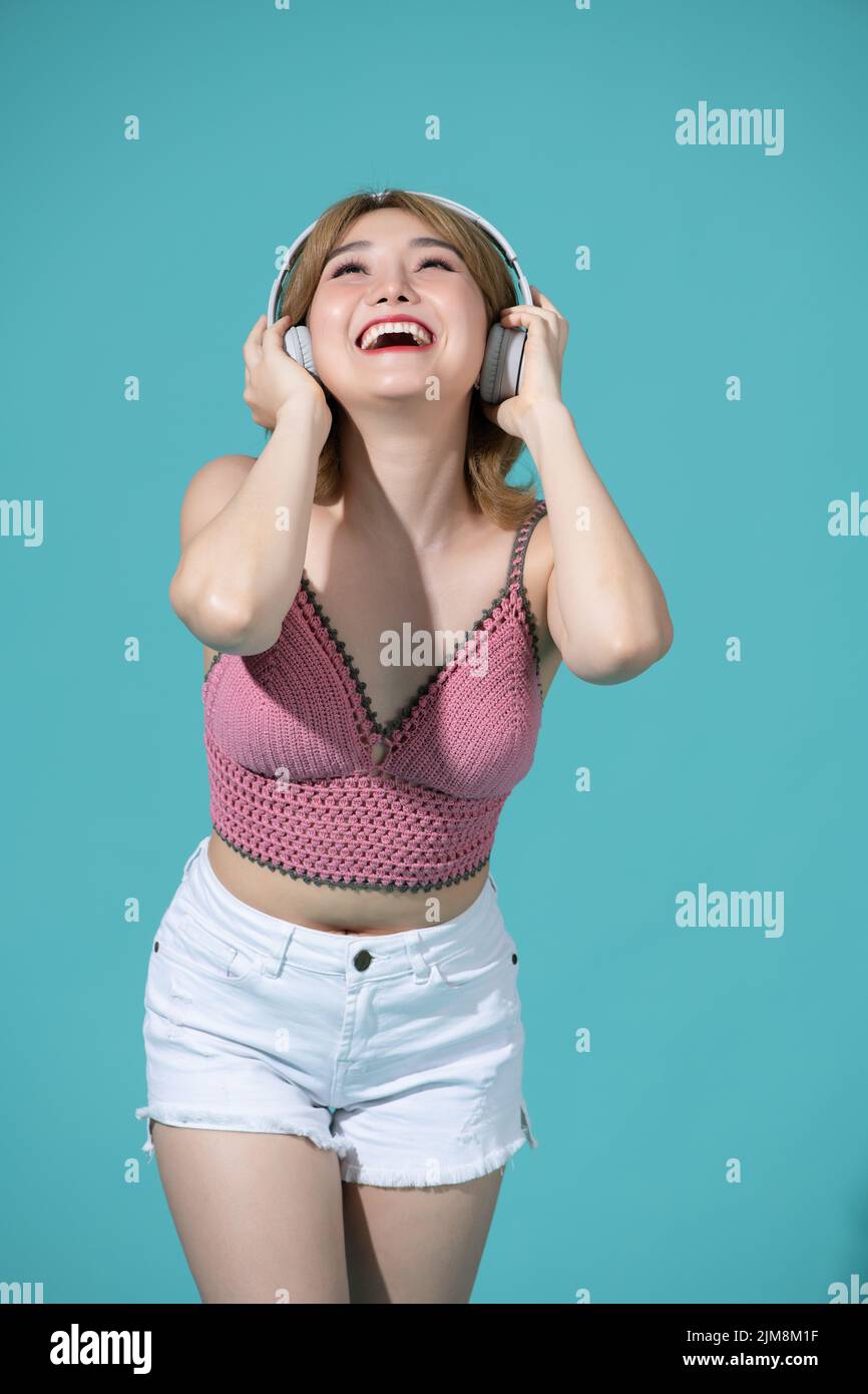 attractive dreamy girl jumping listening, pop mp3 soul single song melody technology virtual connection isolated Stock Photo