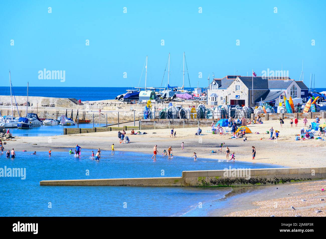 Lyme Regis, Dorset, UK. 5th Aug, 2022. UK Weather: Holidaymakers enjoy a relaxing morning on the beach at the seaside resort of Lyme Regis as the warm and sunny returns. Credit: Celia McMahon/Alamy Live News Stock Photo
